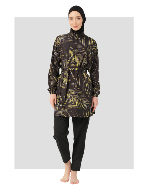 Woman wearing a black and gold patterned burkini modest swimwear from Alor swimwear