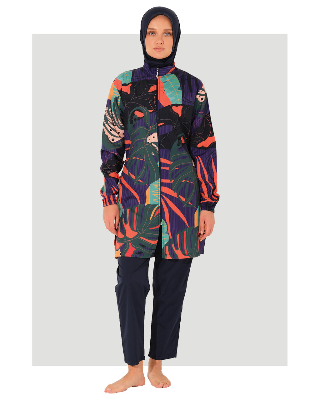 lady wearing a colorful patterned coverall burkini on a white background