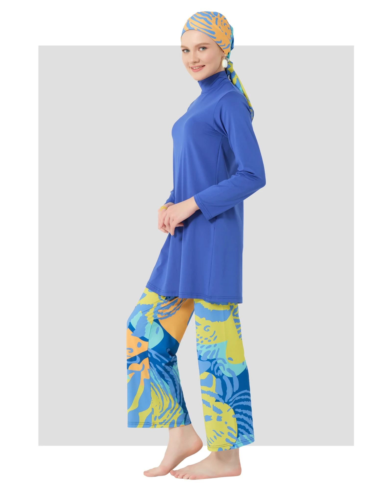 Model in blue burkini with abstract print pants and matching headscarf.