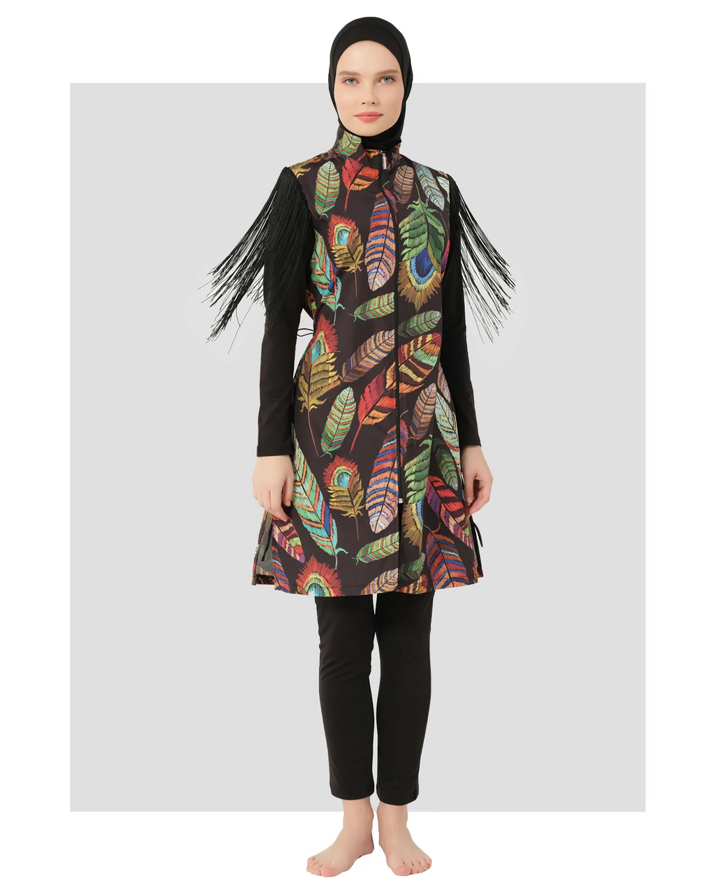 Model in bohemian feather-print burkini with fringe sleeves, front view.