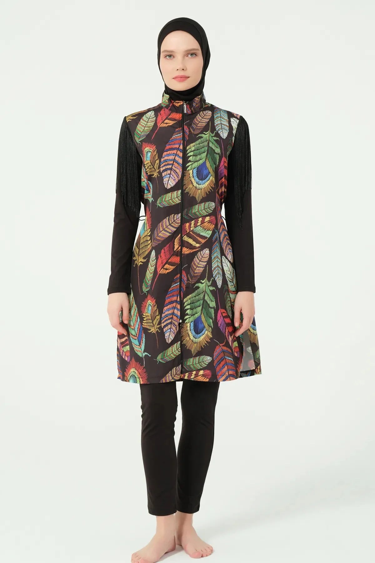 Model in bohemian feather-print burkini, black sleeves, no fringe visible.