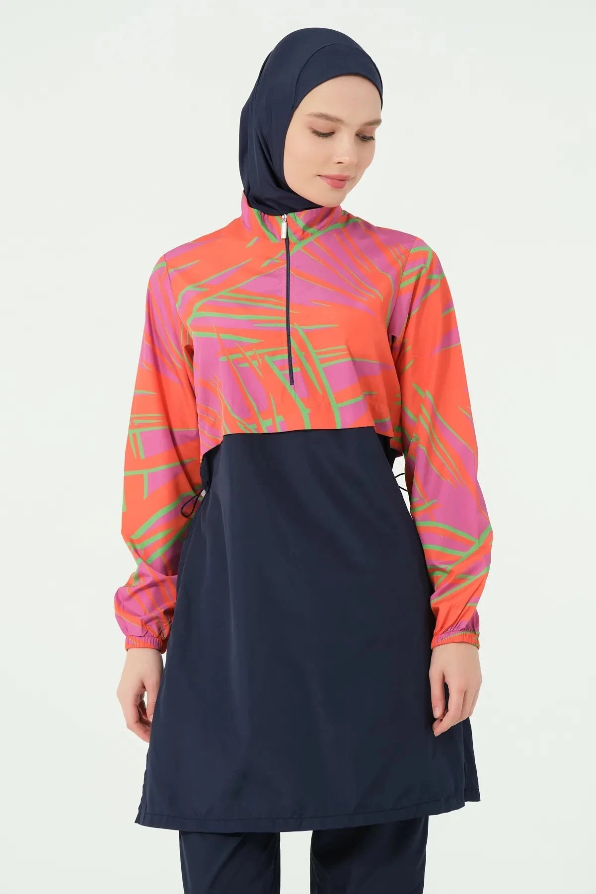 Woman in navy and orange burkini set with hijab, front view.