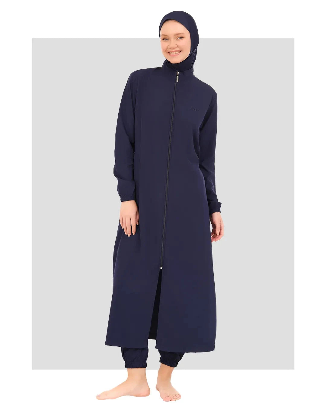 Woman in navy full-length burkini set with zipper, front view.