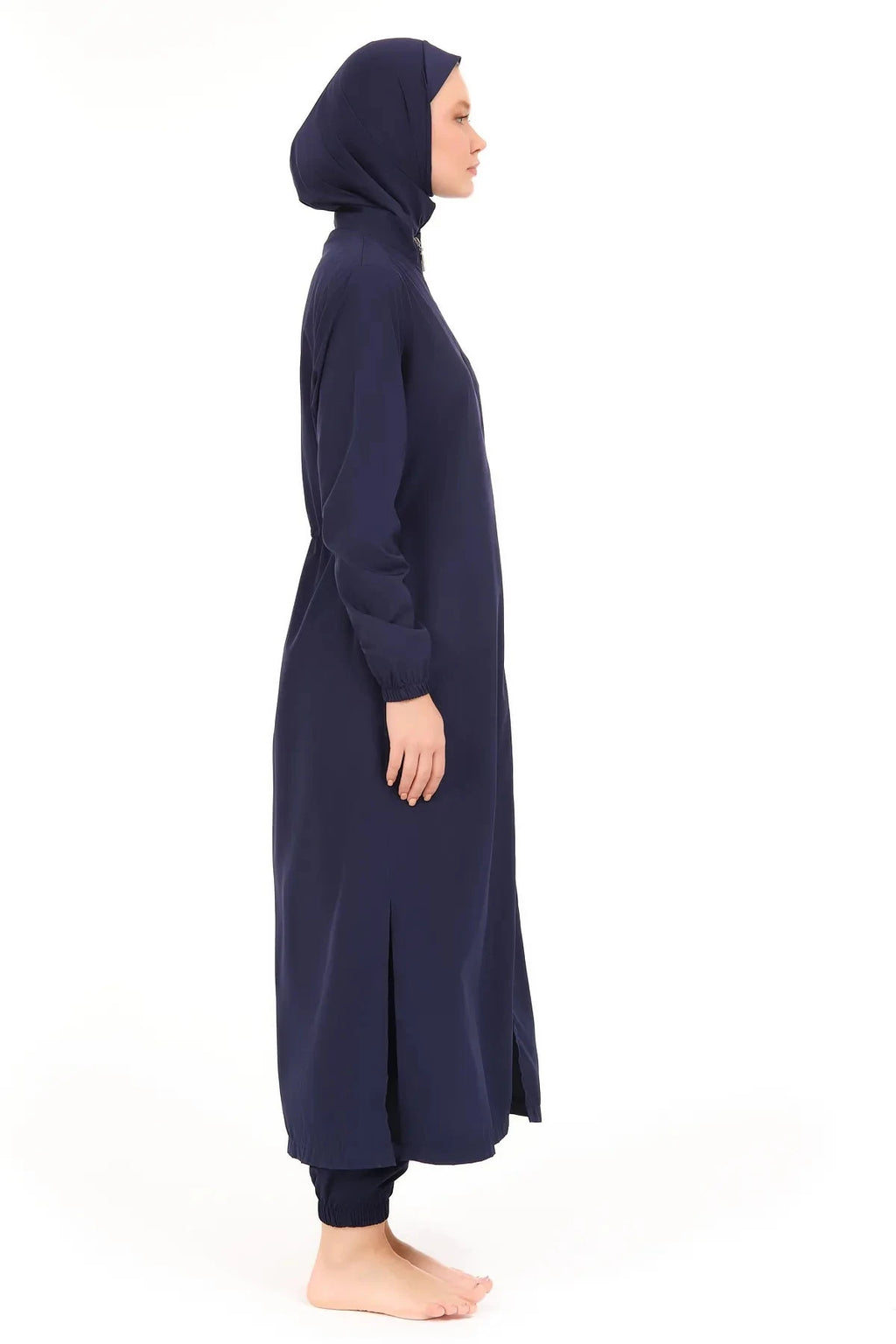 Side profile of woman wearing navy full-length burkini set.