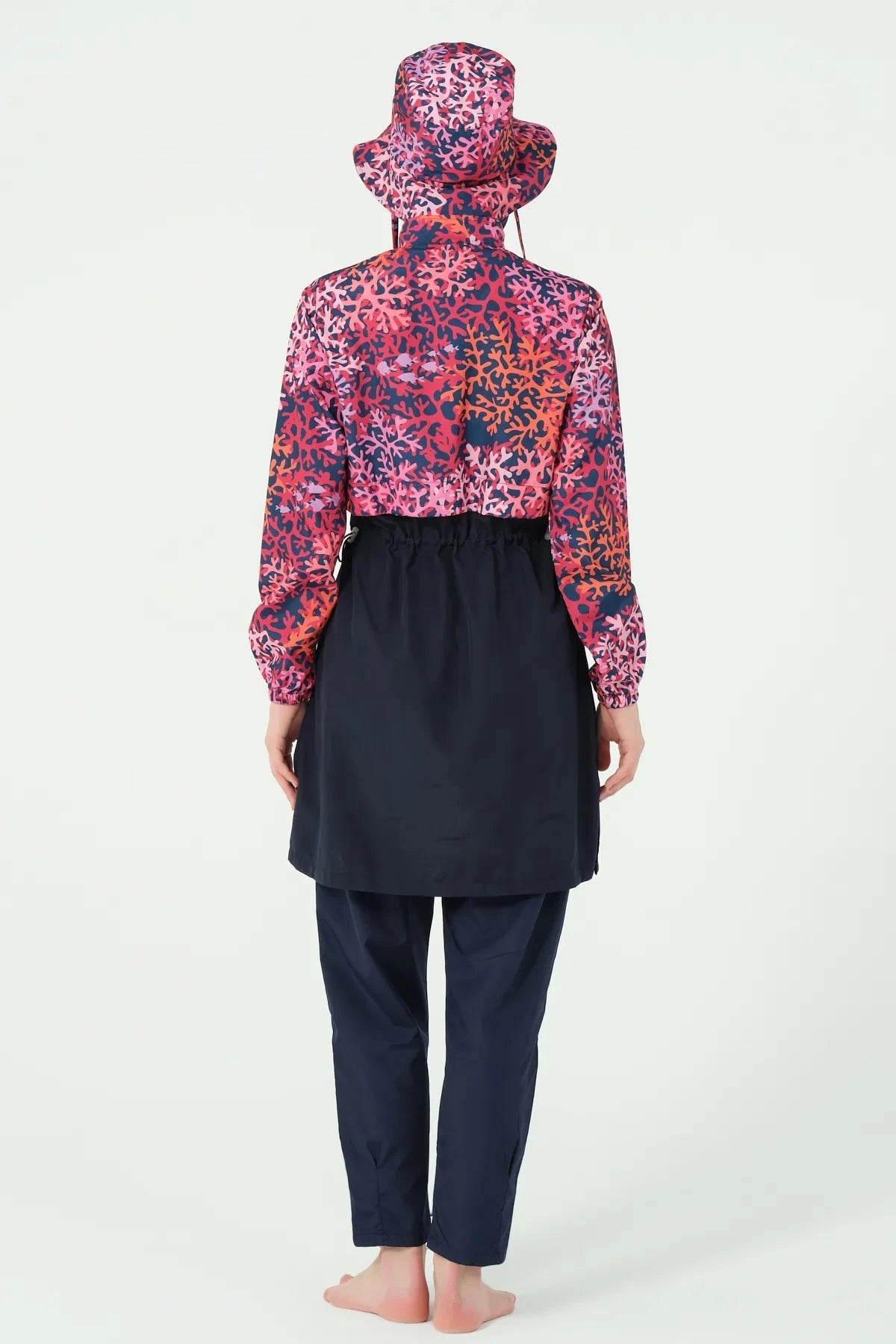 Navy and red coral print burkini set back view on model.