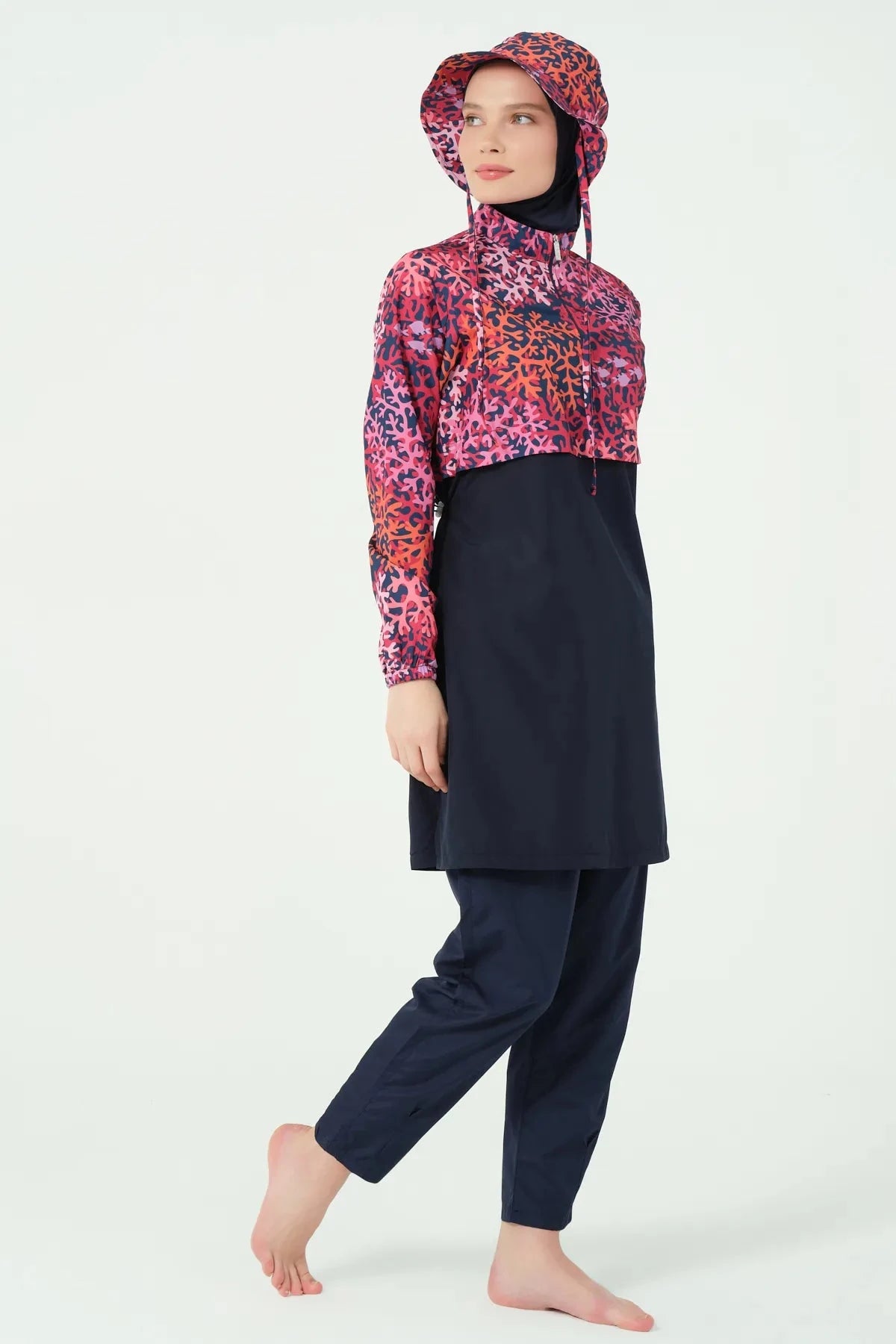 Navy and red coral print burkini set side view on model.