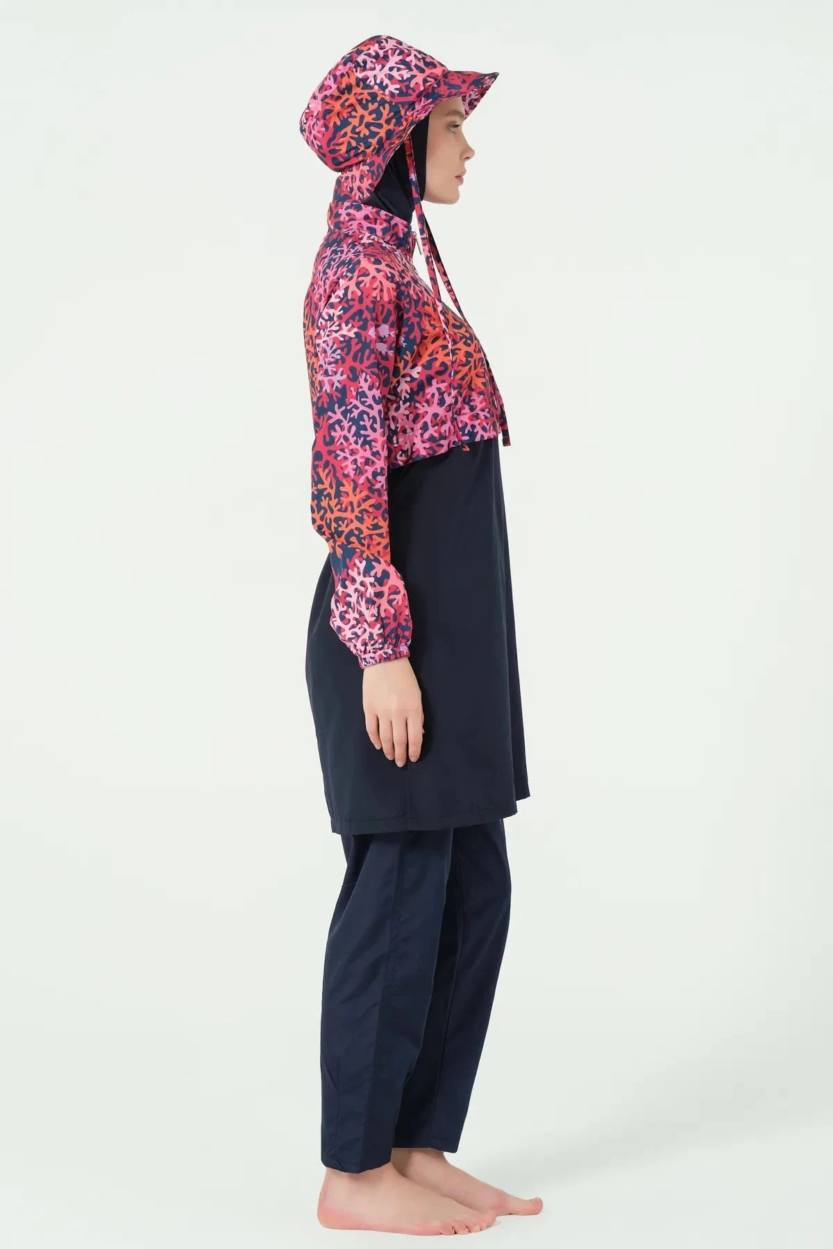 Navy and red coral print burkini set left side view on model.