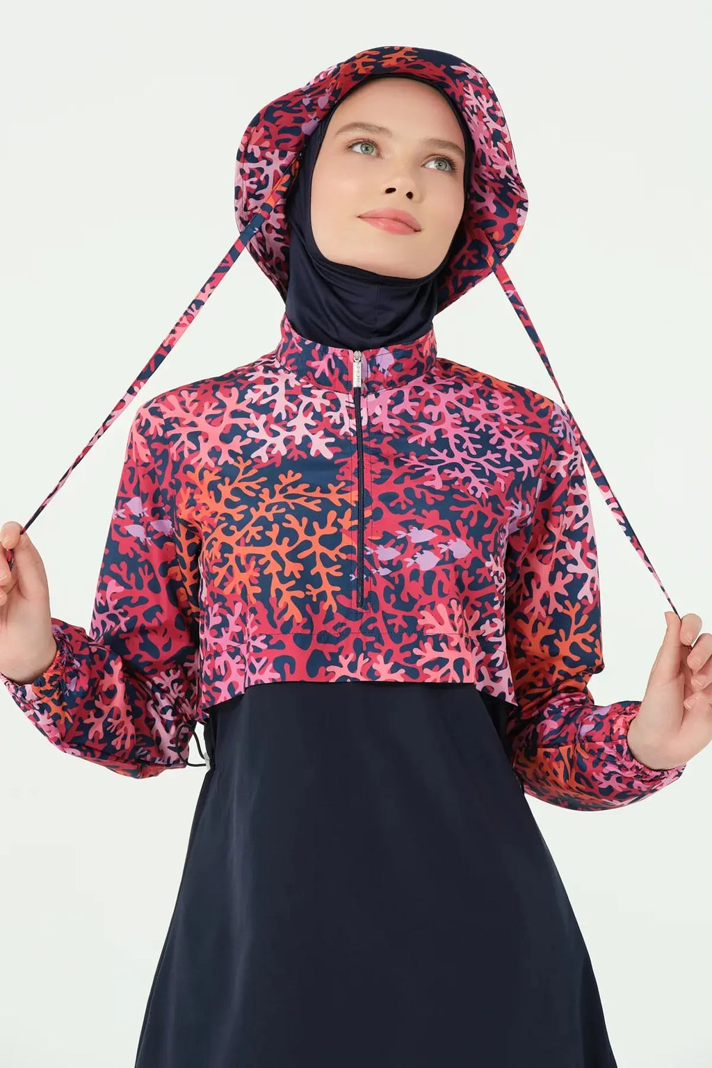 Close-up of coral print burkini jacket and bucket hat on model.