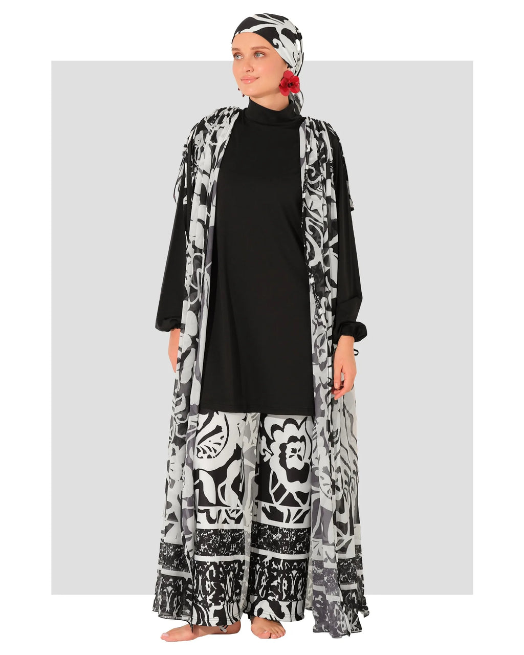 Woman in black and white burkini set with chiffon kimono, front view.