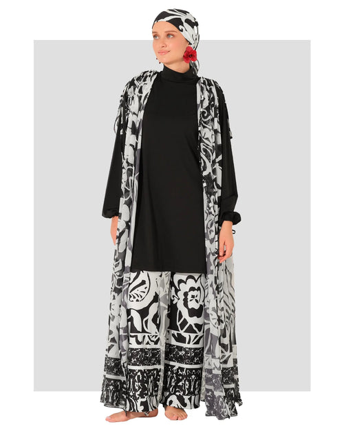 Woman in black and white burkini set with chiffon kimono, front view.
