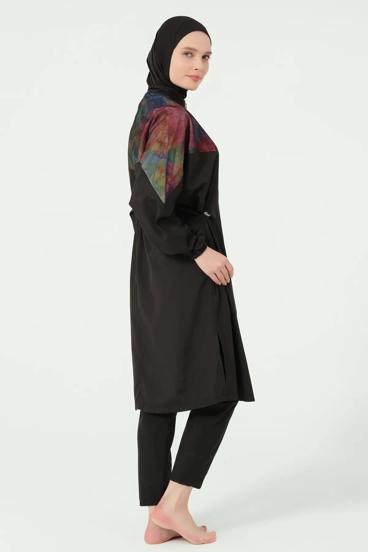 Black burkini set with iridescent shoulder detail, side view.