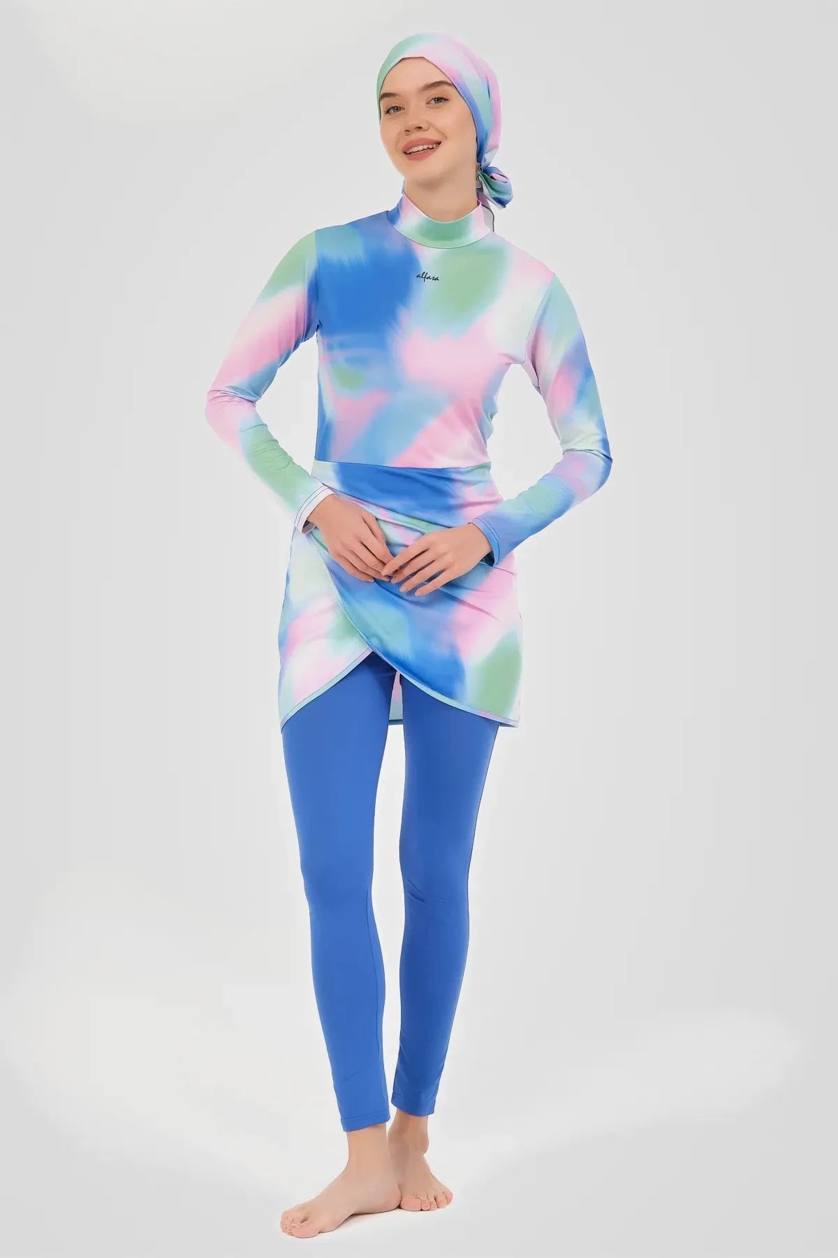 Smiling model in pastel tie-dye burkini set, three-quarter front view.