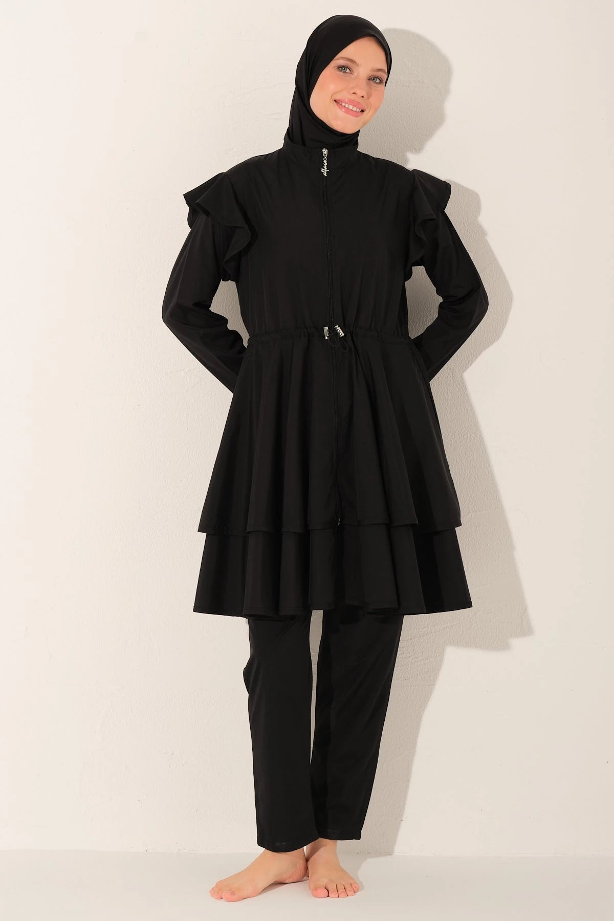 Black ruffle burkini set front view with smiling model.