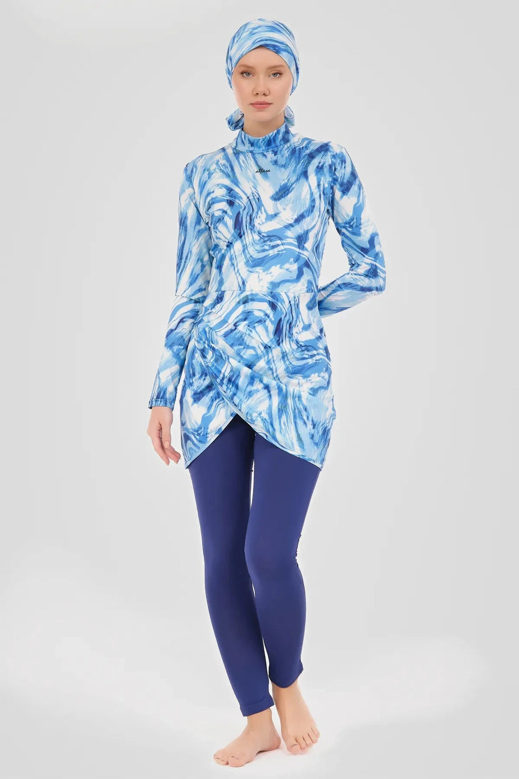 Model in blue wave print burkini top and swim pants, front view.