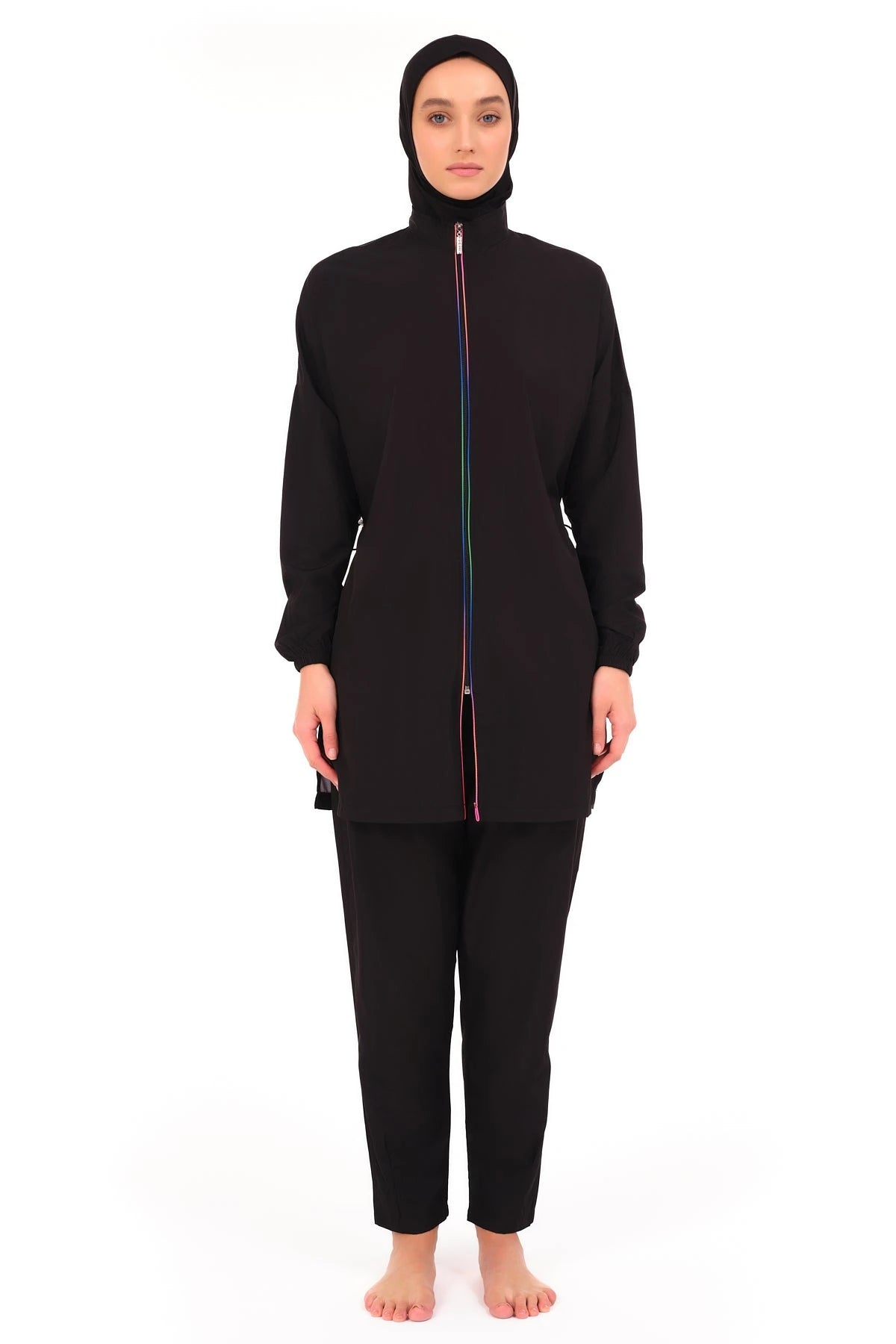 Black modest burkini with rainbow front zipper, model standing.