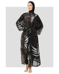 Model in black burkini with gold and white leaf print kimono.