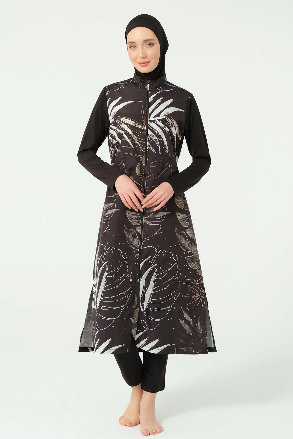 Front view of black burkini top with gold and white leaf print.