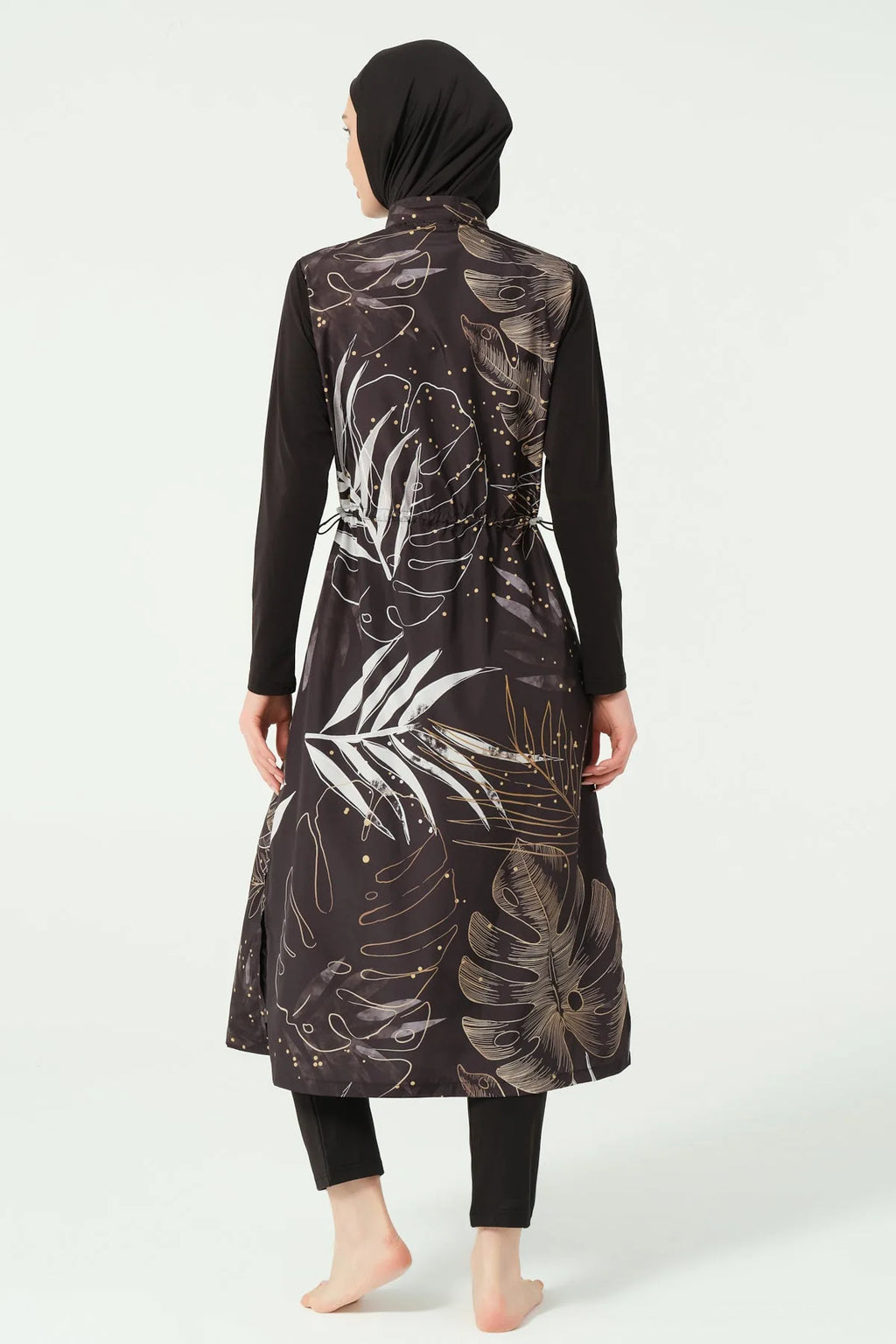 Back view of black burkini top with leaf print and black swim pants.