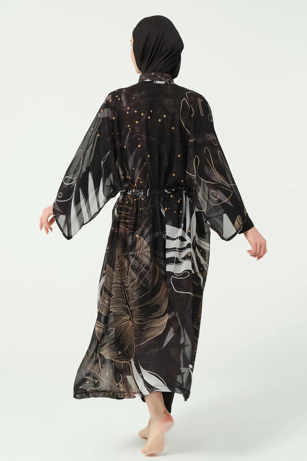 Back view of black burkini with gold and white leaf print kimono.