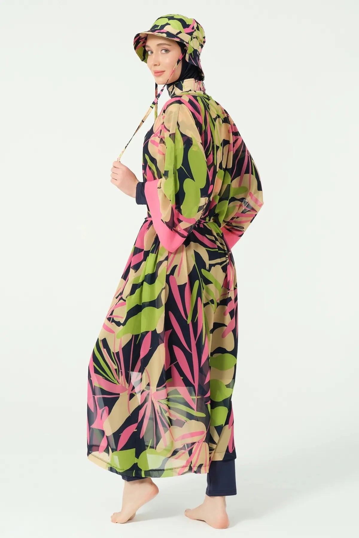Profile view of tropical print burkini set with sheer kimono and bucket hat.