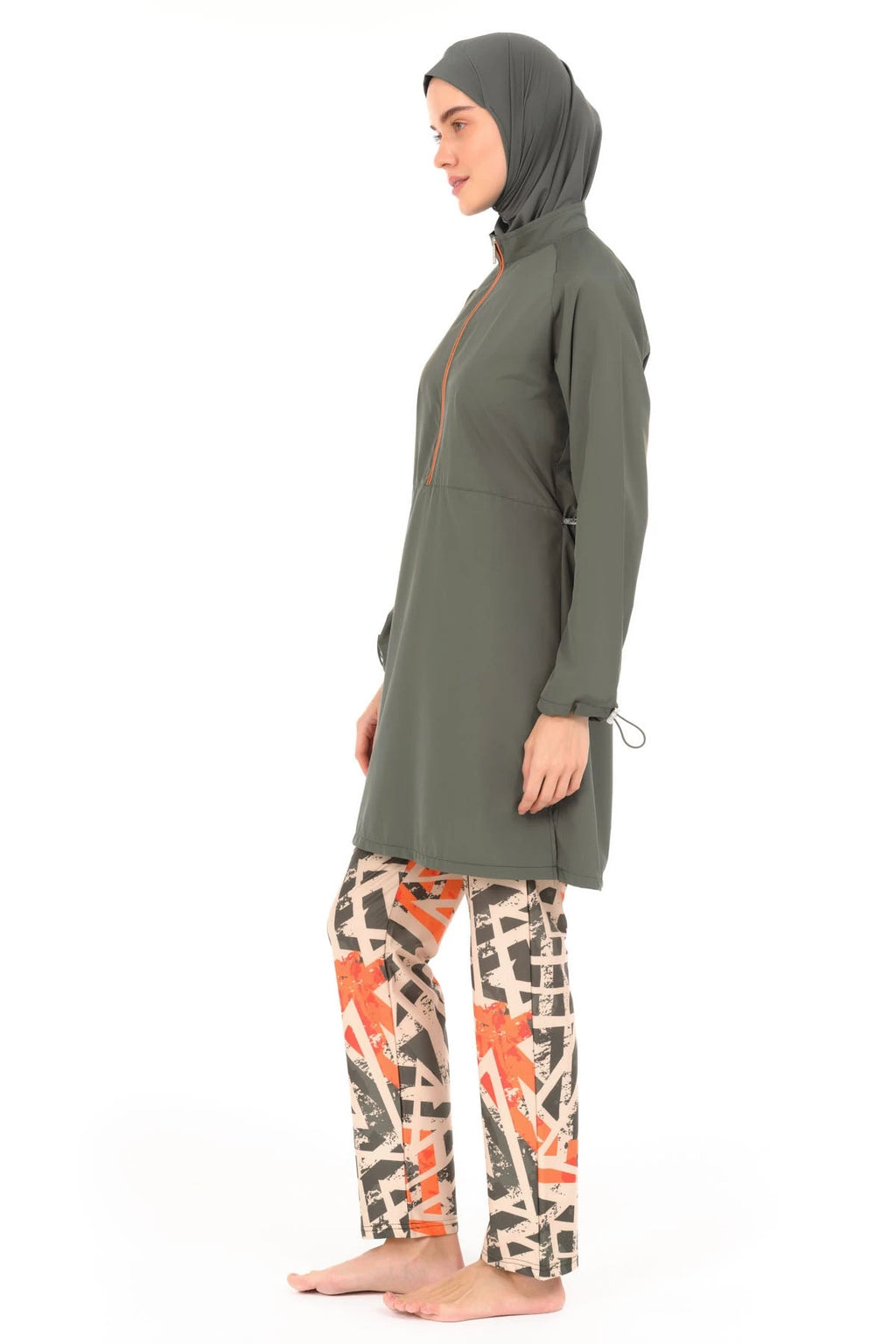 Woman in modern burkini with geometric print pants, side view.