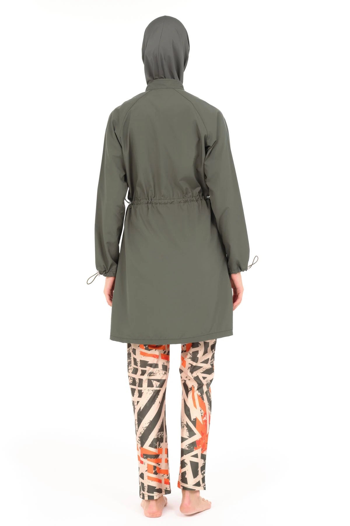 Woman in modern burkini with geometric print pants, back view.
