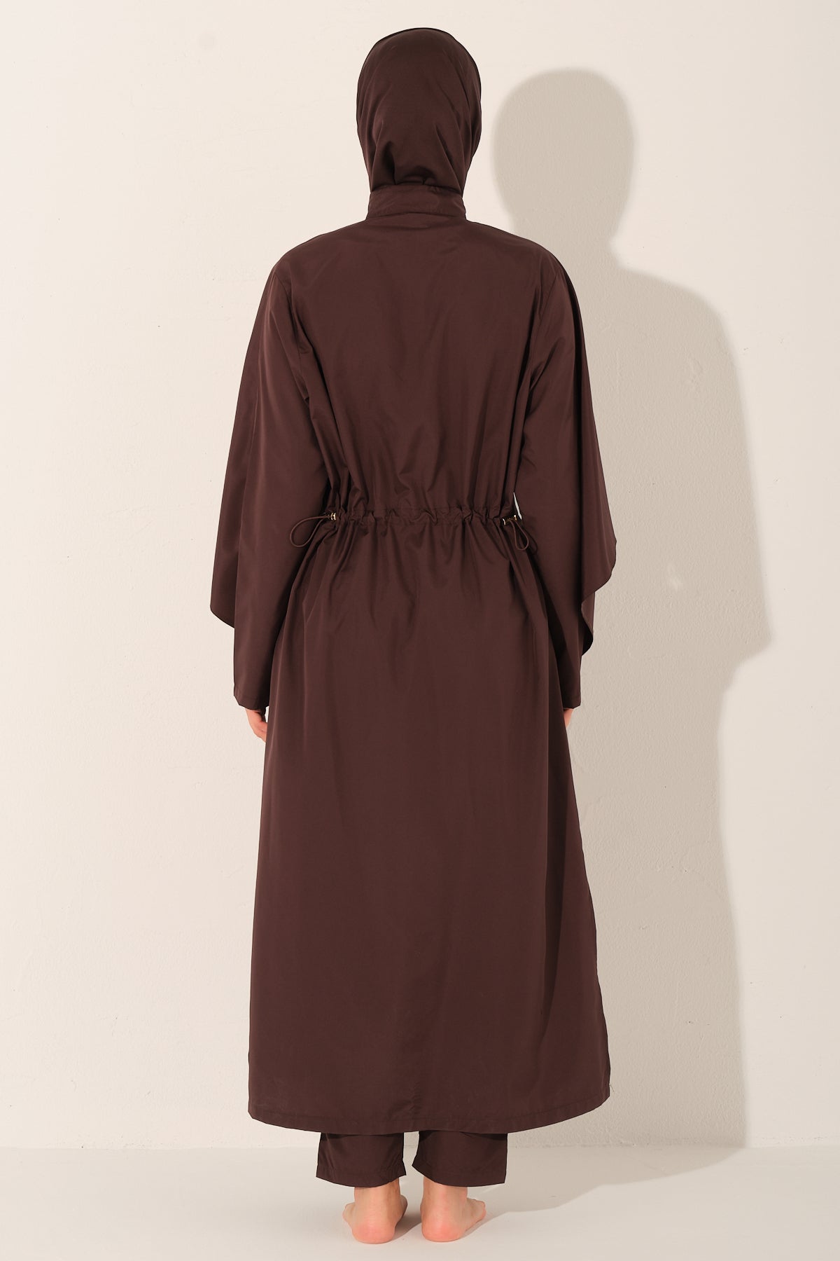 Brown abaya swimwearby a person on a white background