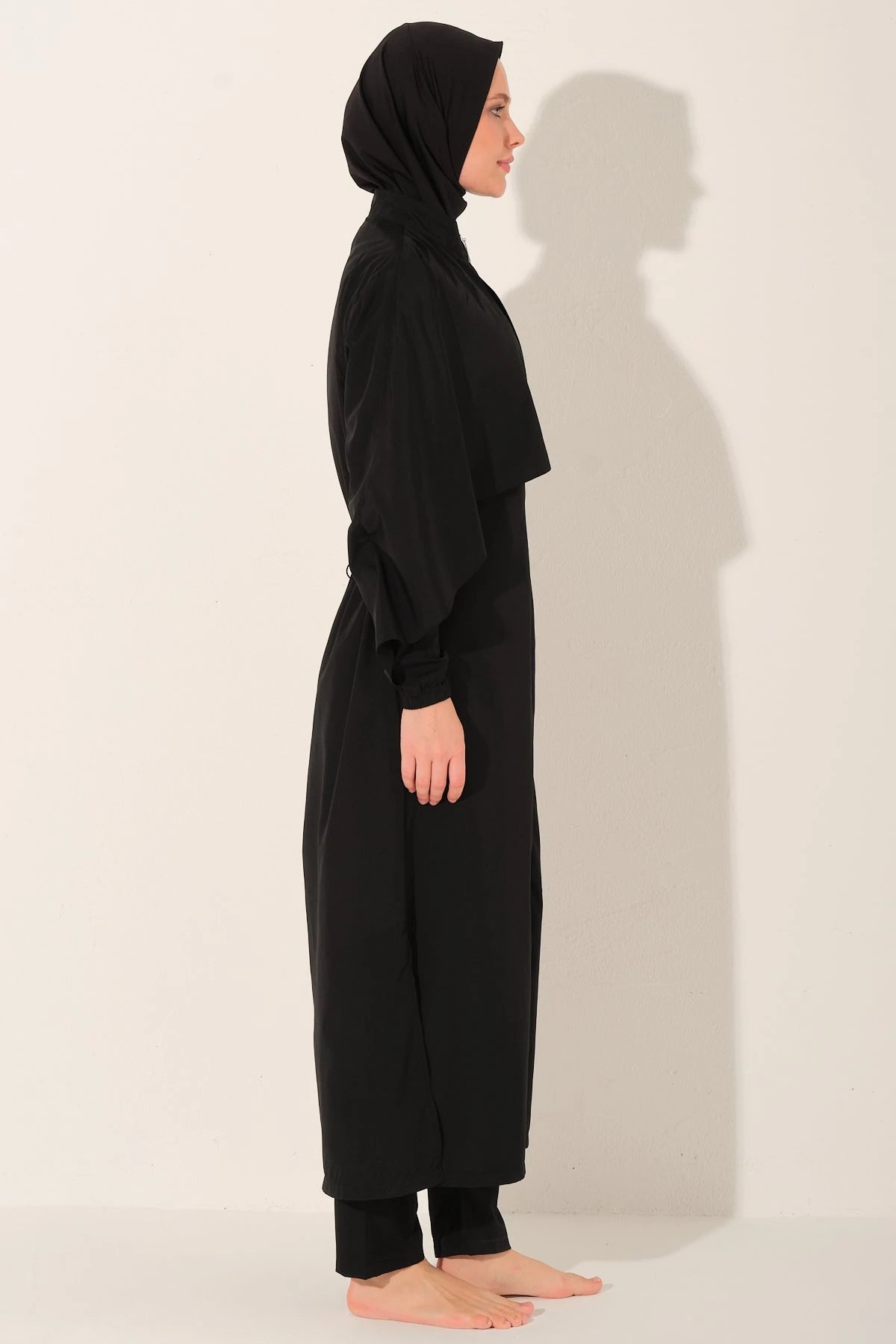 Black burkini set side profile view on a white background.