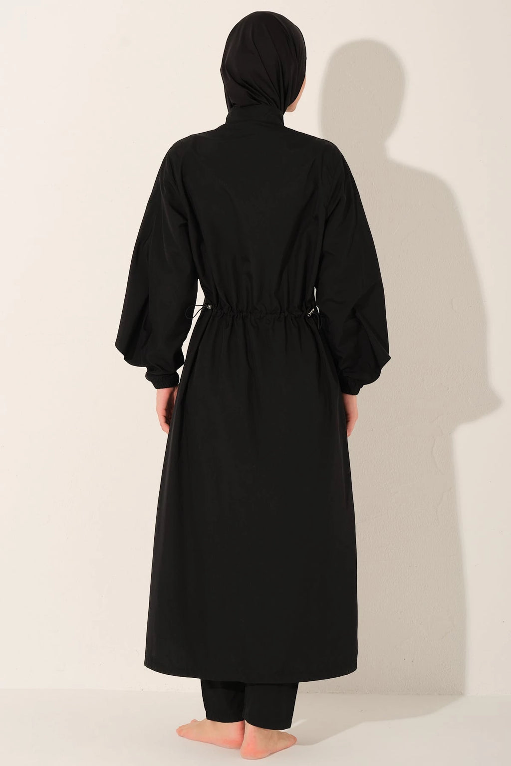 Black burkini set back view with adjustable drawstring waist.