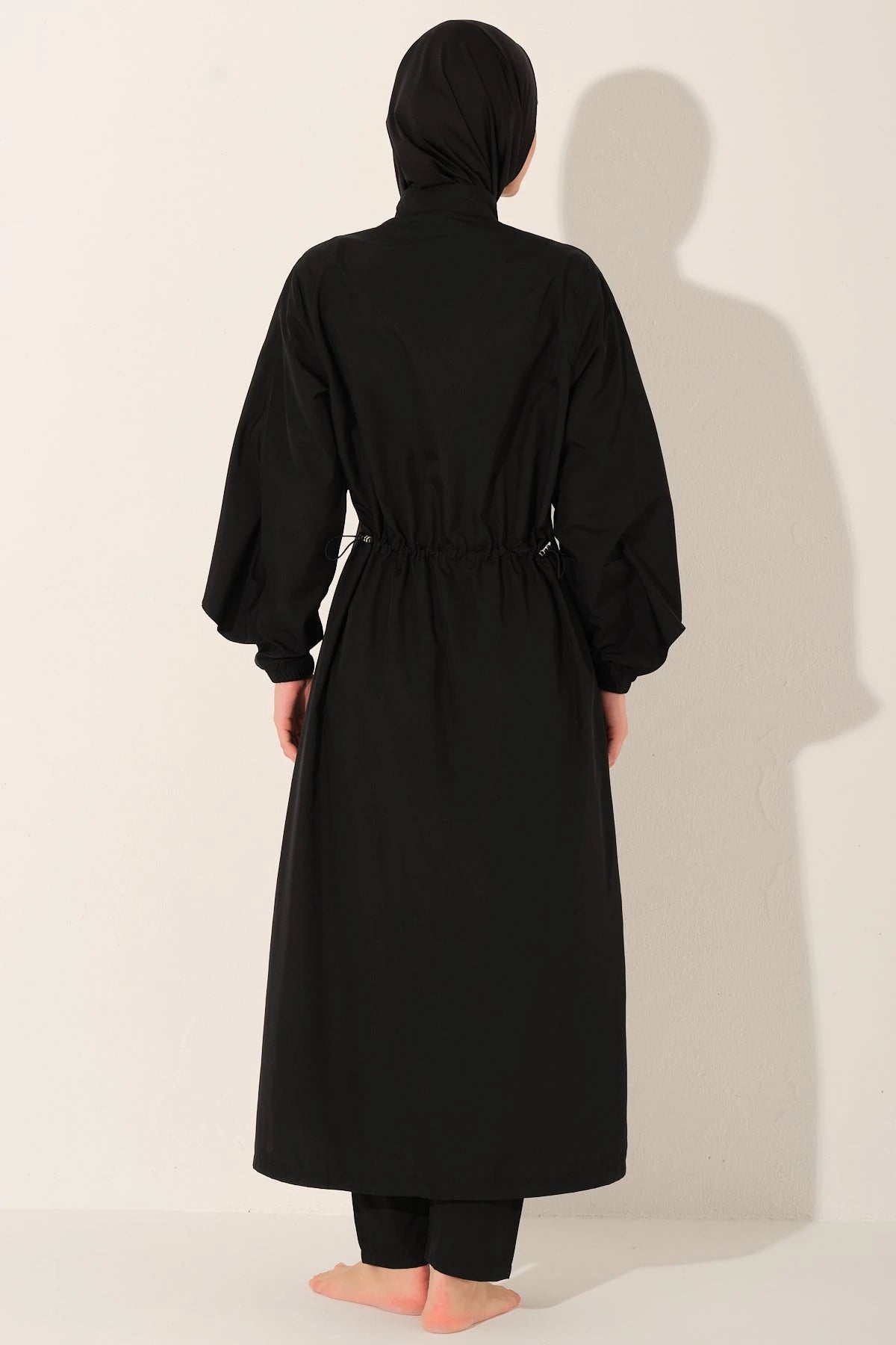 Black burkini set back view with adjustable drawstring waist.