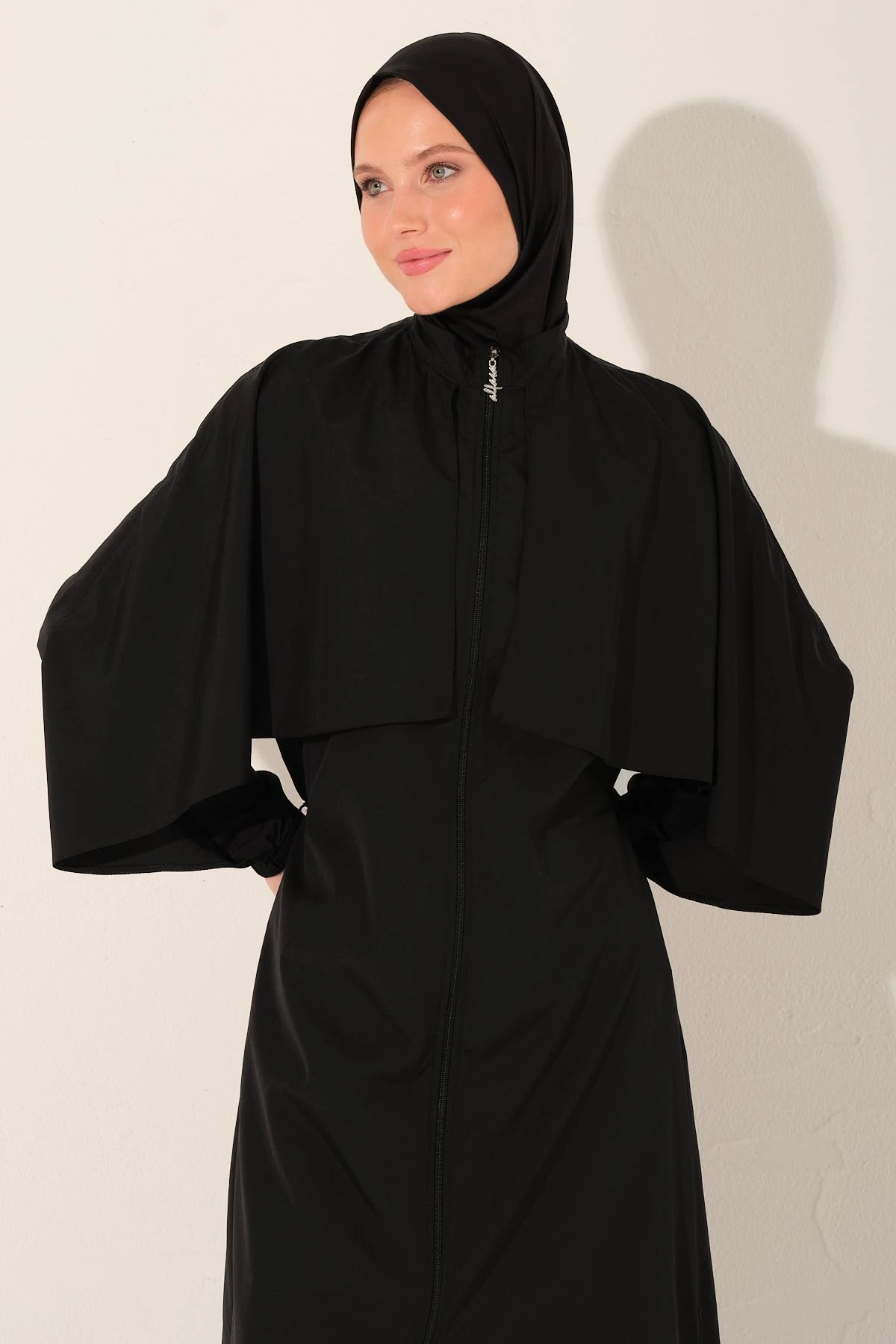 Close-up of black burkini top with modest coverage.