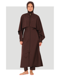 A woman wearing a dark brown modest long-sleeve abaya burkini with a high collar, a front zipper, and a draped cape-style overlay, paired with a matching hijab, standing against a light gray background.