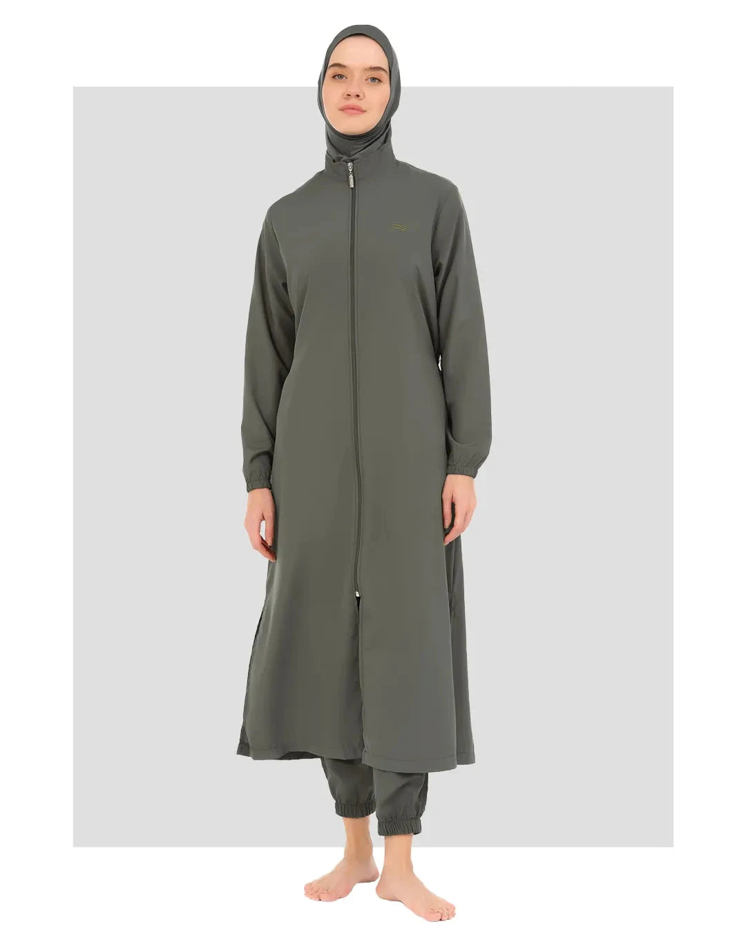 Model wearing olive green full-length burkini with zipper closure front view.