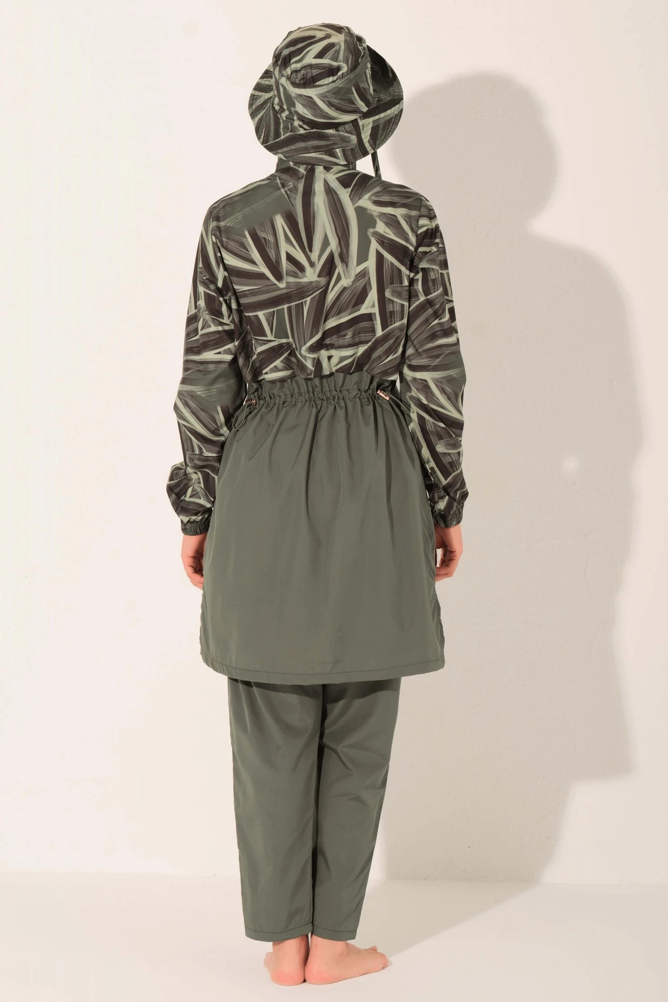 Back view of olive green burkini with patterned top and full coverage pants.