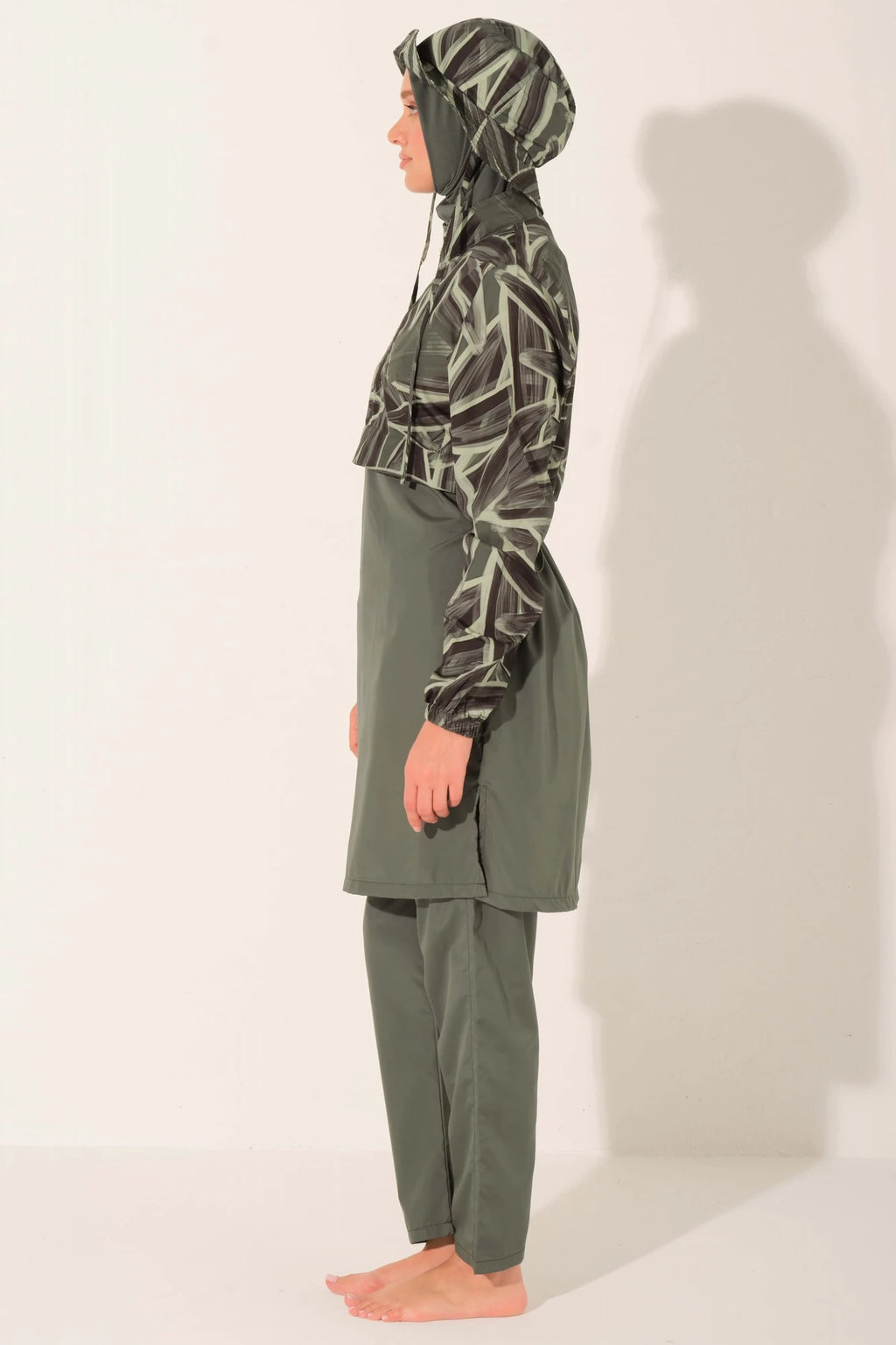 Side view of olive green burkini with patterned top and full coverage.
