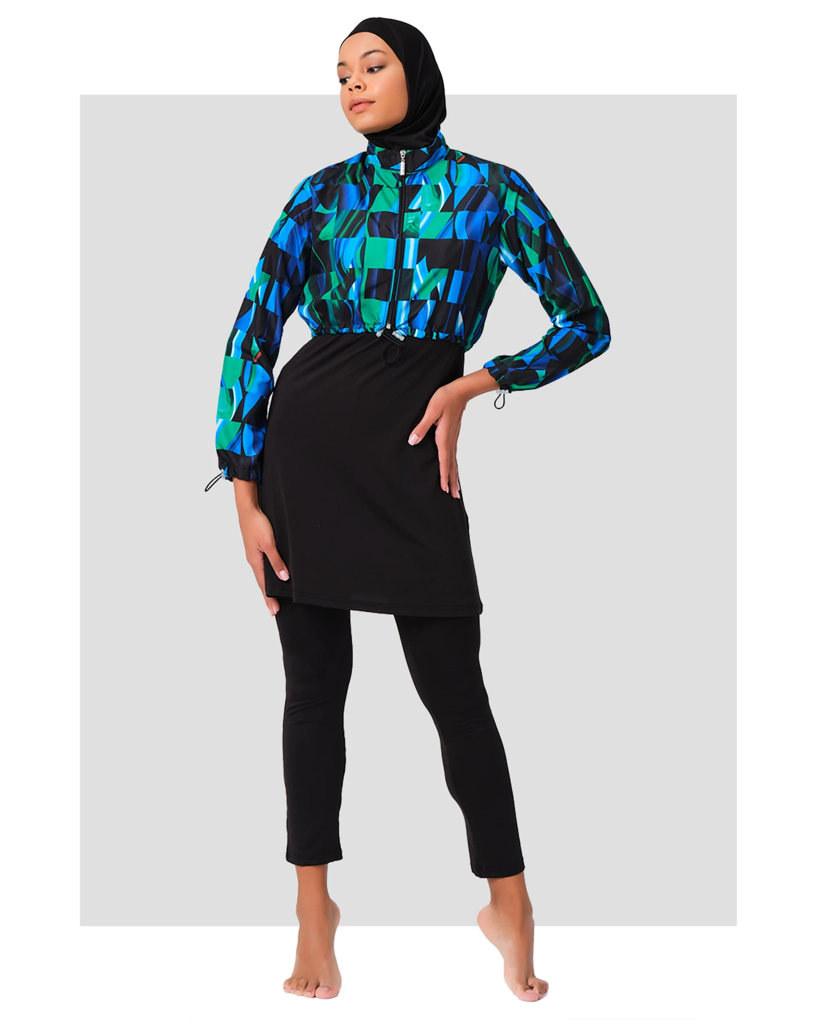 Woman in sporty burkini with blue green abstract print jacket front view.