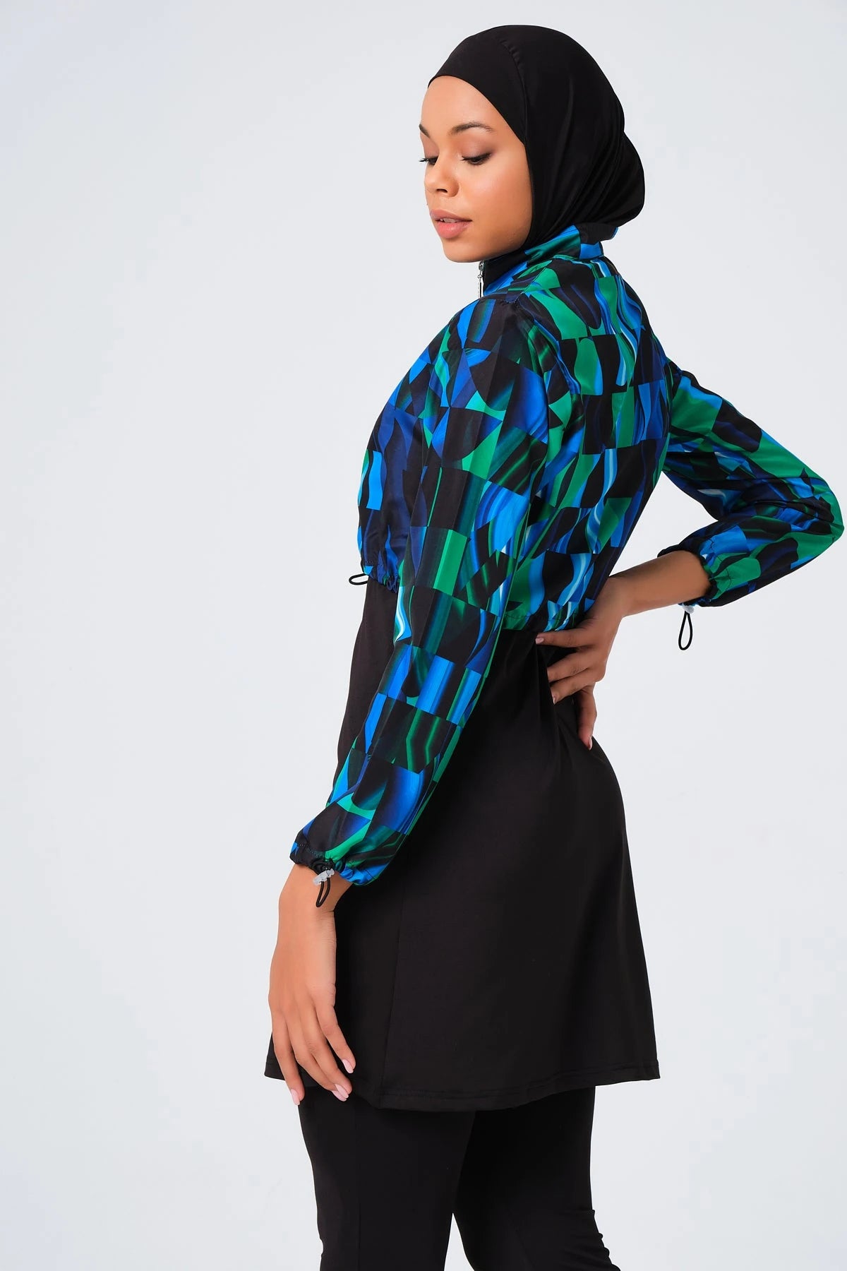 Sporty burkini with blue green abstract print jacket side view.