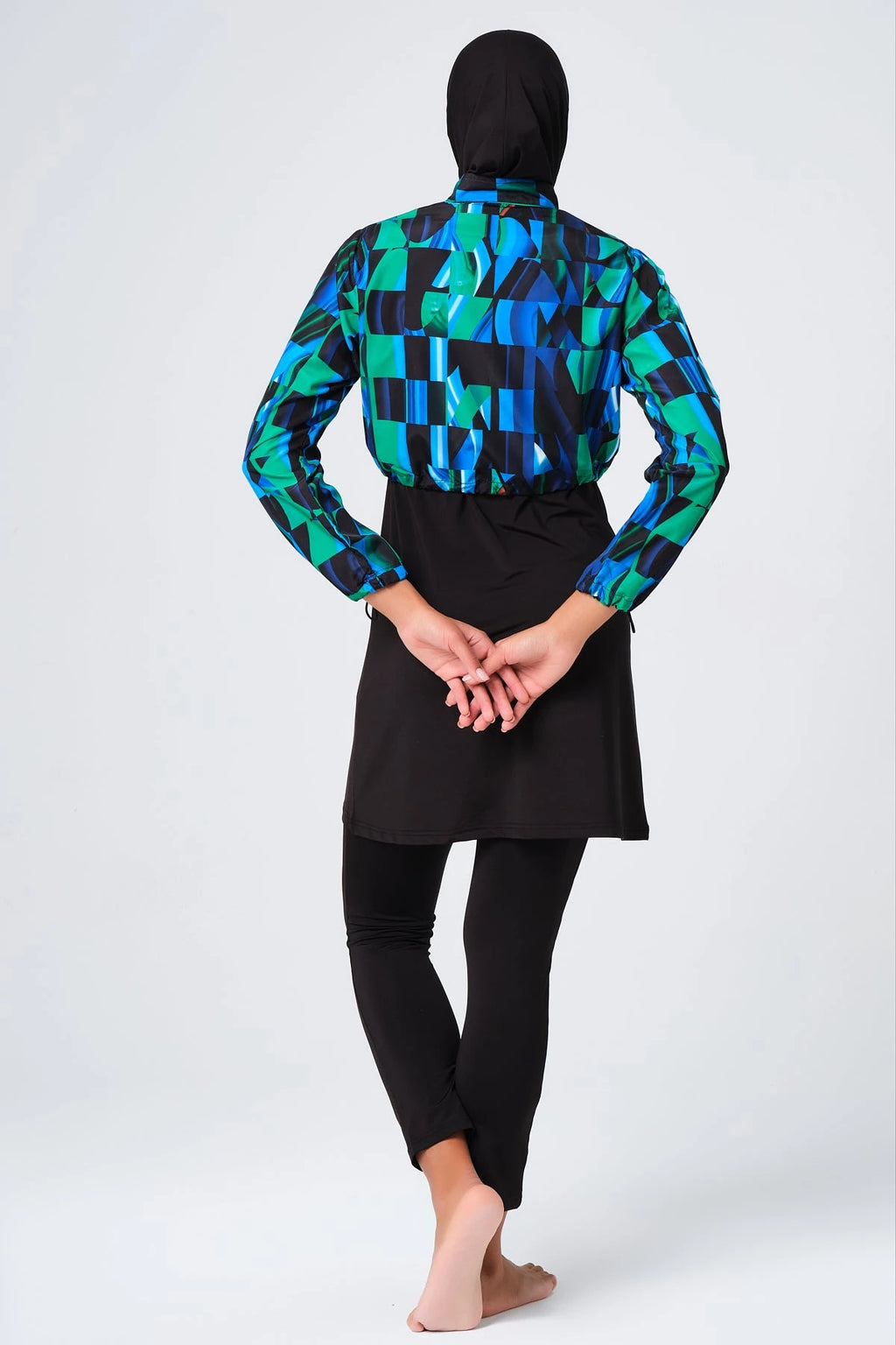 Sporty burkini with blue green abstract print jacket back view.