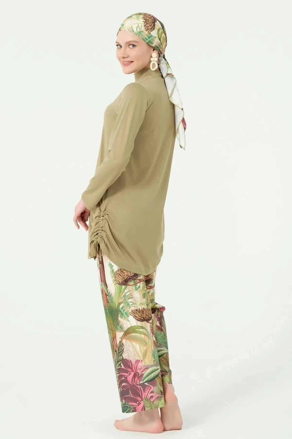 Khaki burkini with botanical print pants and ruched sides, side view.