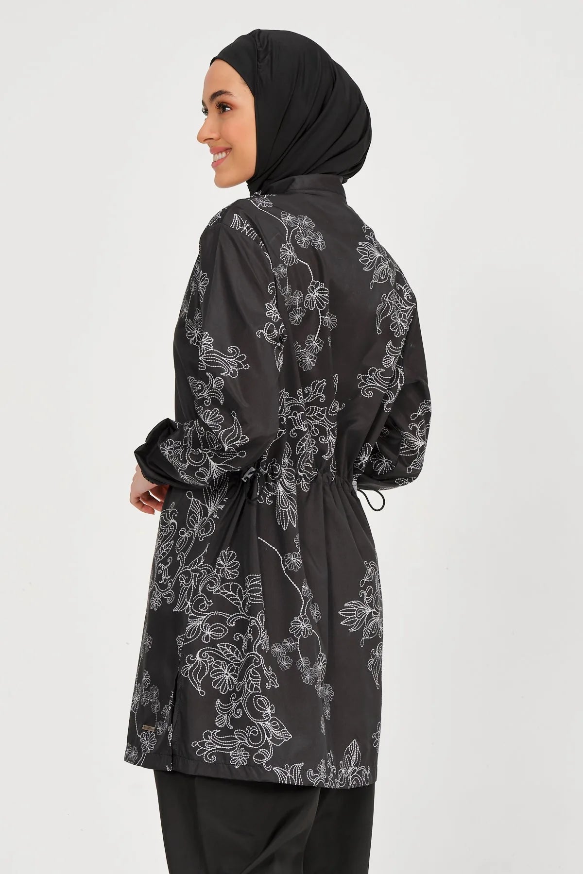 Black burkini set with white floral embroidery, back detail.