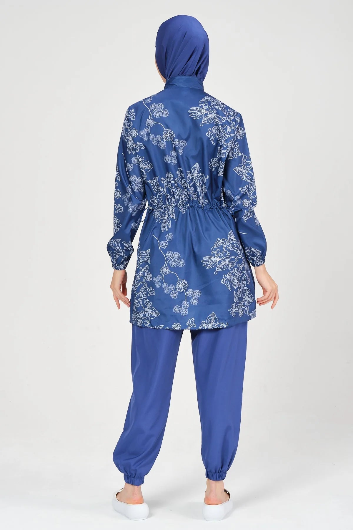 Blue burkini set with floral embroidery, back view, on white background.