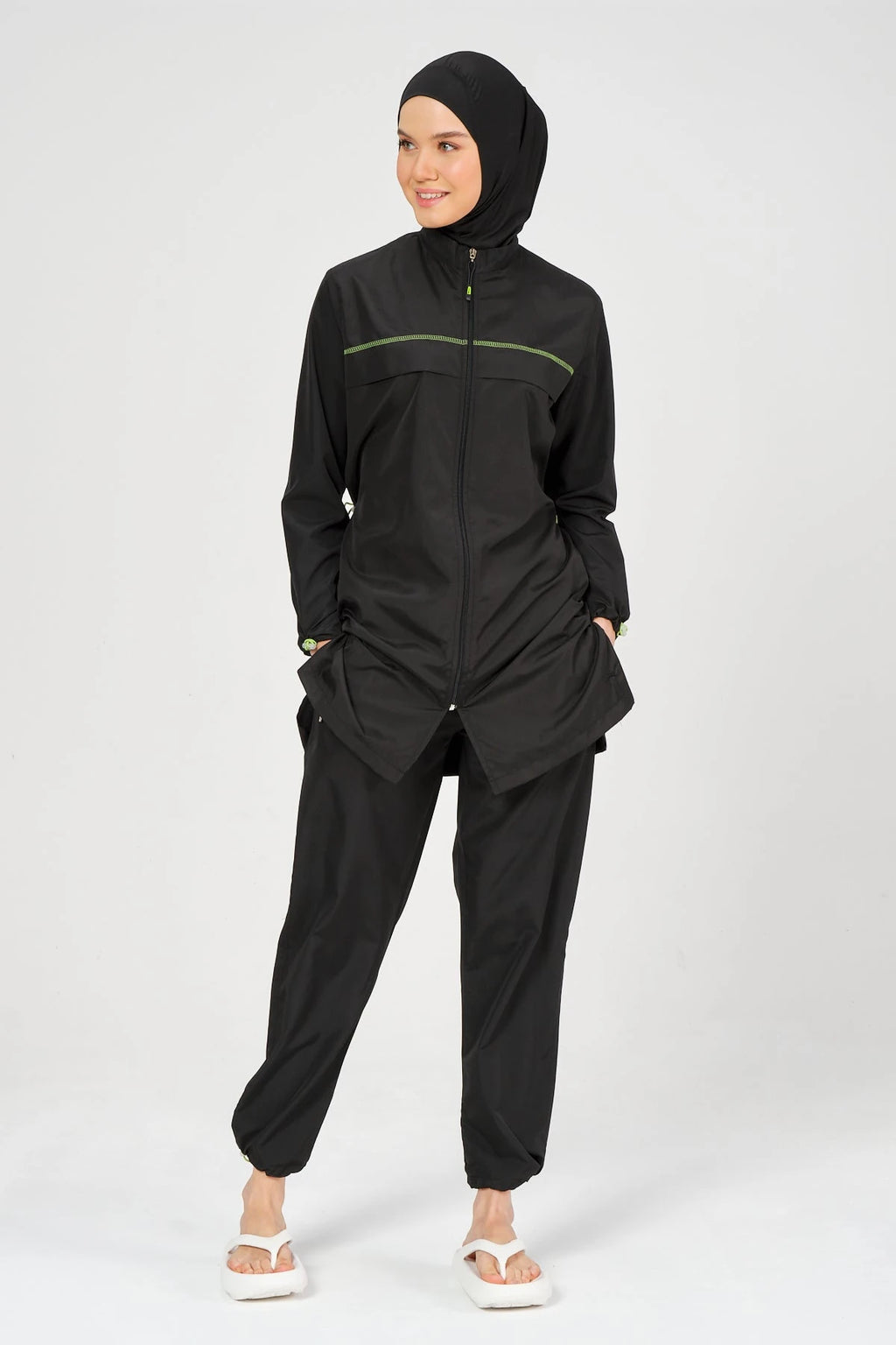 Full body view of black burkini set with neon accents and hijab.