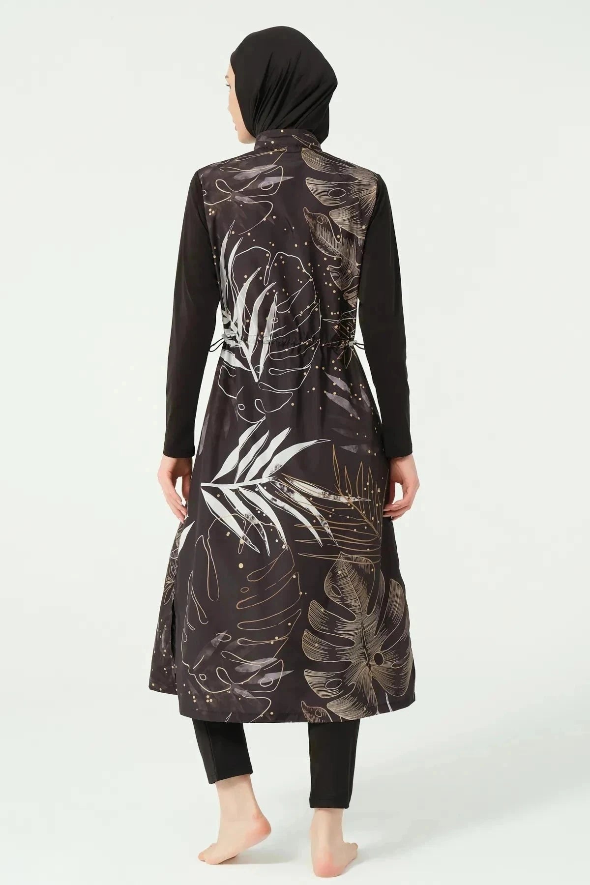 Black burkini with gold and white leaf print, back view with tie belt.