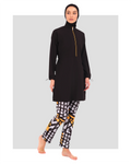 Woman in black burkini top and geometric print swim pants.