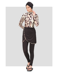 Woman wearing leopard print burkini swimsuit with black turban, front view.