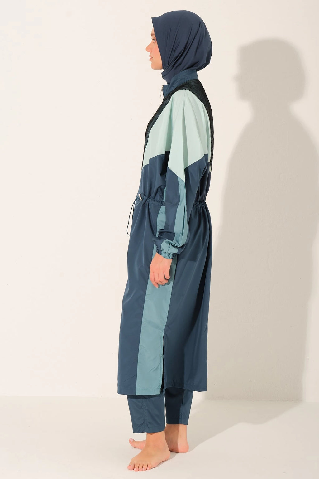 Side profile of Petrol Pulse burkini showing full coverage.