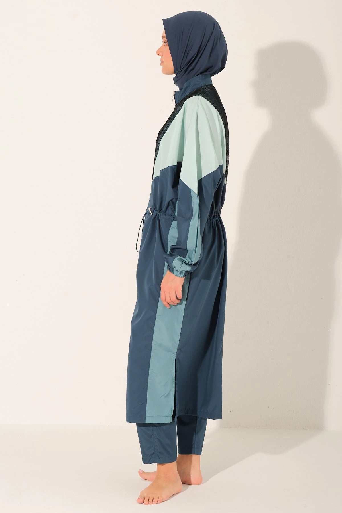 Side profile of Petrol Pulse burkini showing full coverage.