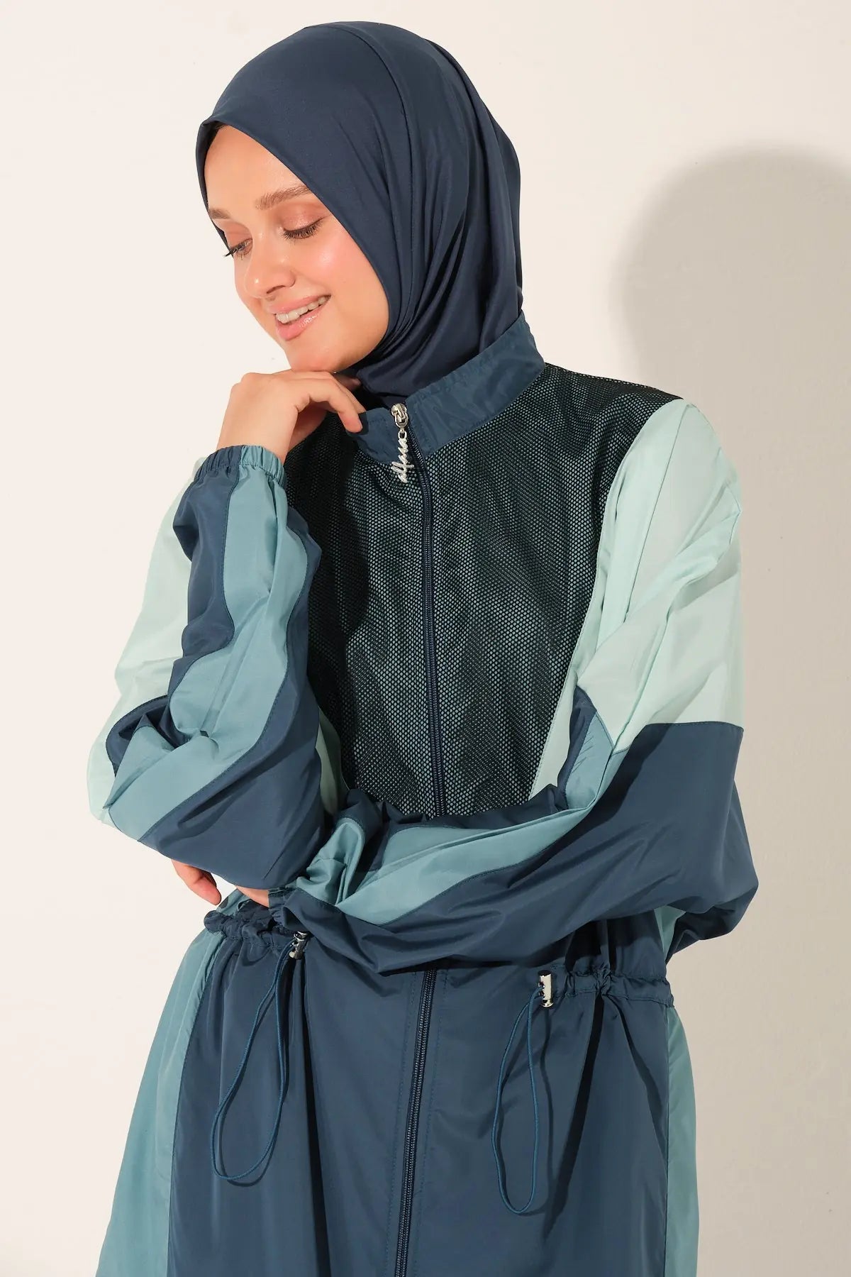 Close-up of Petrol Pulse burkini top with zipper and hijab.