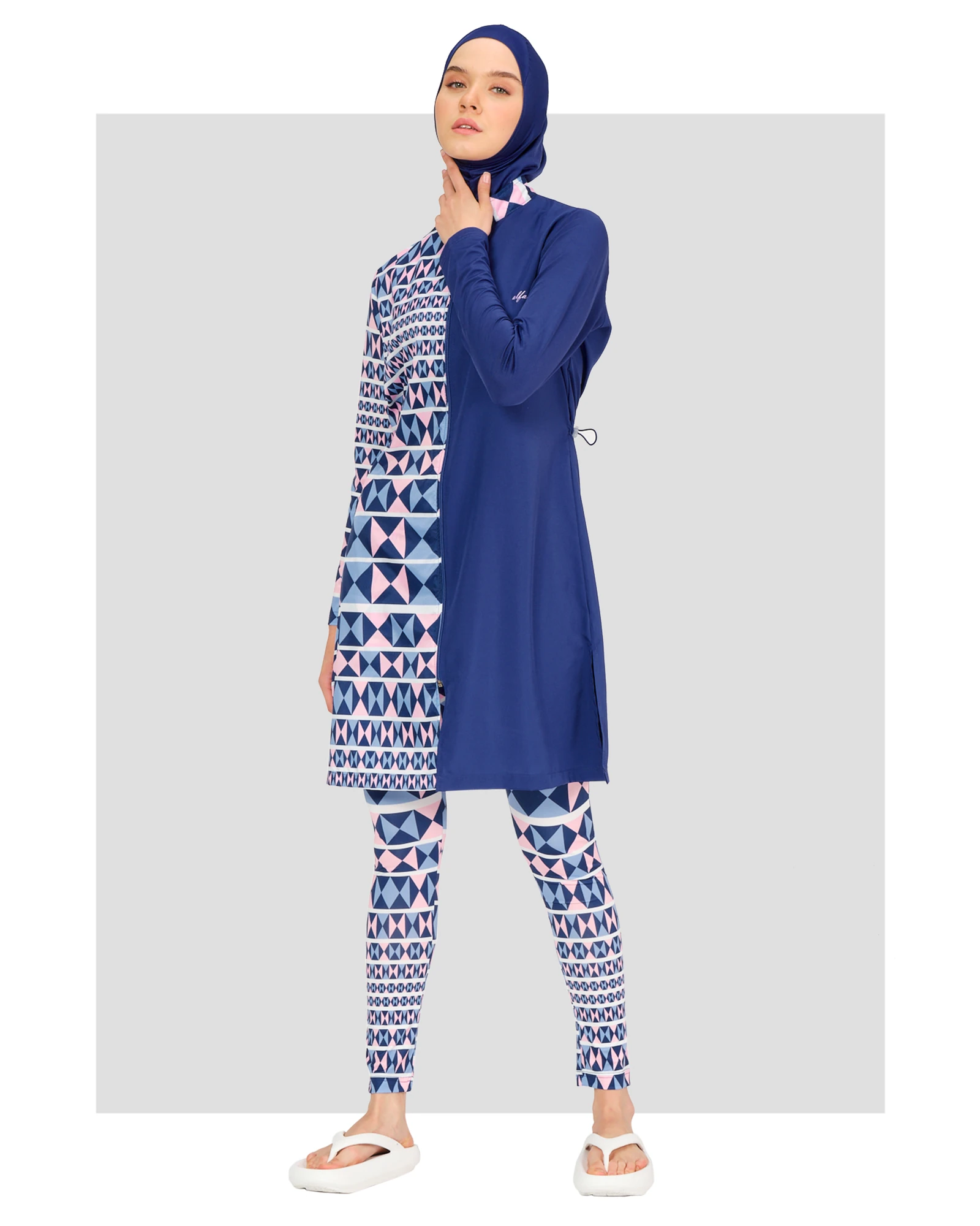 Model in blue and geometric patterned burkini front view.