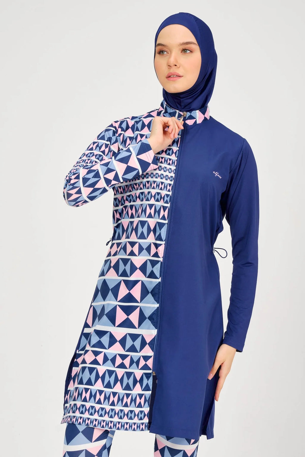 Model adjusting zipper on blue burkini top collar.
